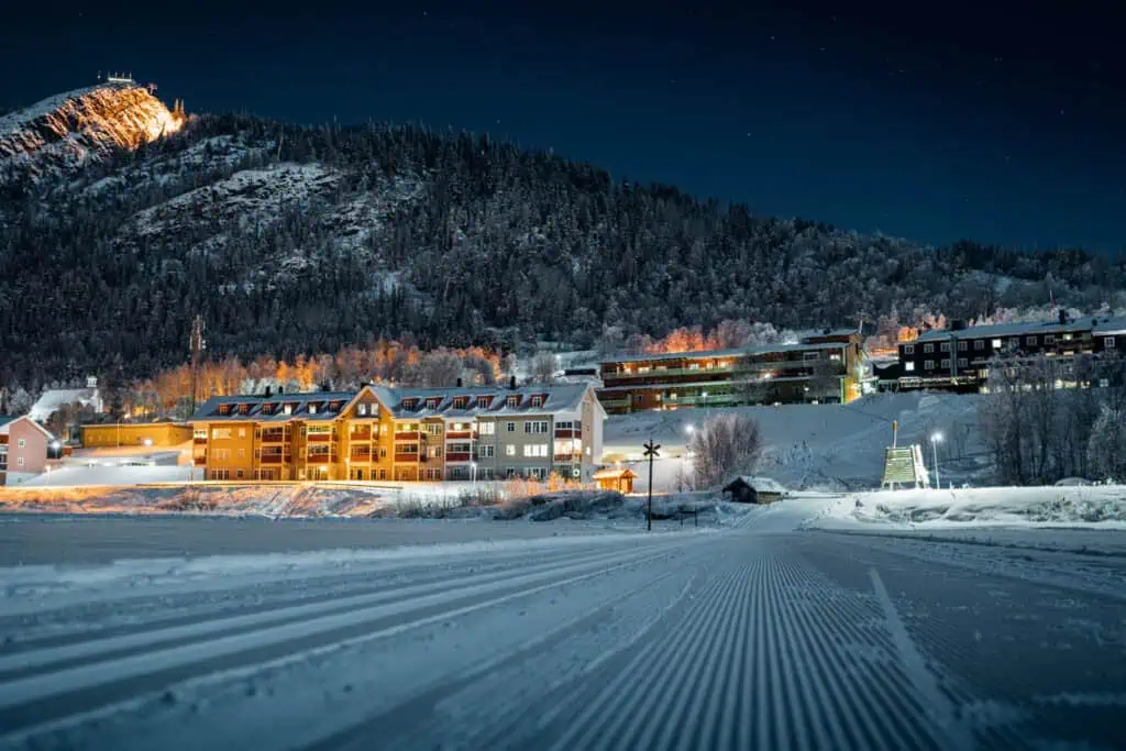 Snow-covered ski resort in Funäsdalen during winter with mountain views and chalets.